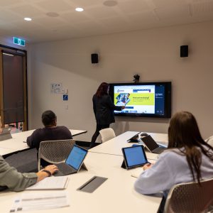 Four people using meeting room space