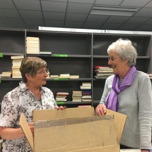 Two volunteers unpacking a box