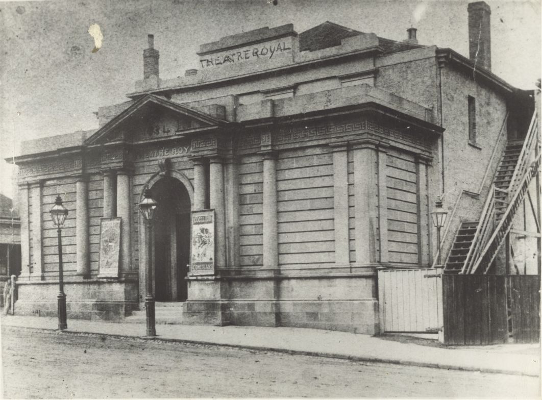 The front of a brick building as seen from the street